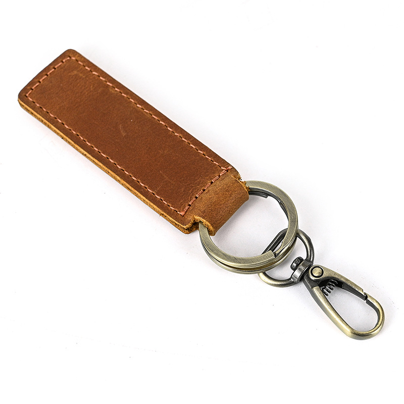 Porte clé en cuir de vachette marron 80x27mm et 2 anneaux bronze 30mm, unité